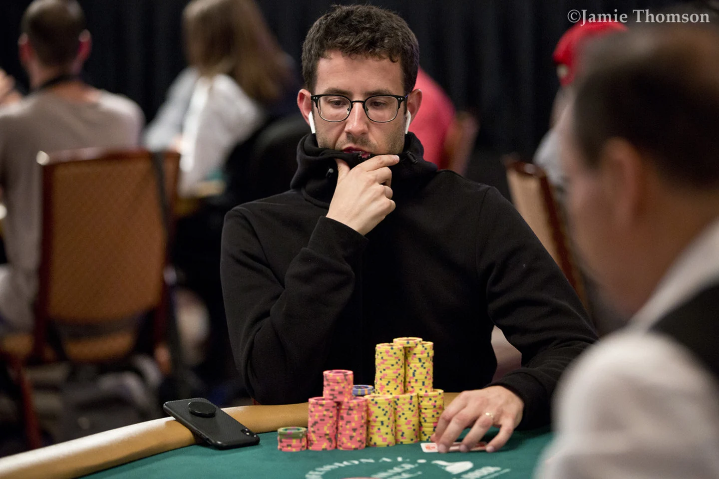 Greg Merson seated at a tournament poker table
